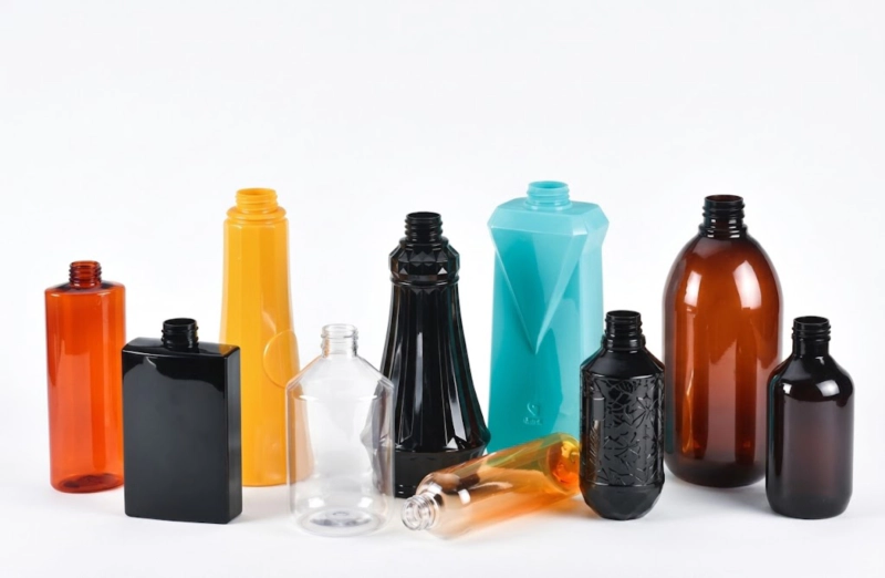 Finished PET bottle samples — clear, standard round format produced by two-step reheat stretch blow molding for cosmetics, pharmaceutical and food applications